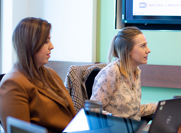 Two women professionals participating in a meeting.