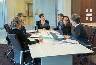 A group implementation science employees gathered around a table