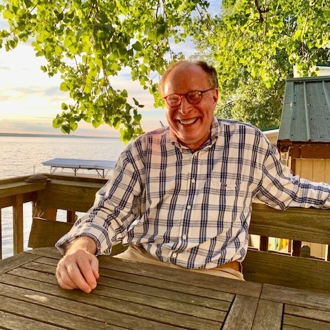 Bob sitting at a bench and smiling